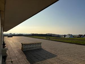 a bench sitting on top of a patio at sunset lodge calais in Calais