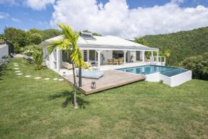 a villa with a swimming pool and a house at Villa Andrea in Case-Pilote