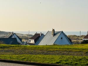 a group of houses in a field with the ocean in the background at sunset lodge calais in Calais