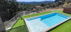 an overhead view of a swimming pool on a green lawn at Villa piscine et jacuzzi la madonnette in Spéracèdes