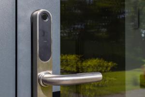 a metal door with a handle on a window at Giruliai loft in Klaipėda