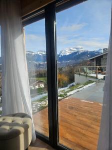 a large window with a view of snow covered mountains at Le Petit Chalet in Saint-Jorioz +16 photos