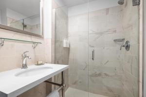 a bathroom with a sink and a shower at Cartwright Hotel Union Square - BW Premier Collection in San Francisco +49 photos