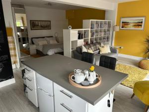 a kitchen and living room with a table and a couch at The Studio in Dunfermline