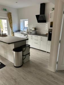 a kitchen with white cabinets and a counter top at The Studio in Dunfermline