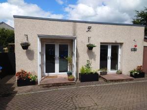 a house with potted plants on the front of it at The Studio in Dunfermline