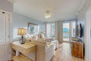 a living room with a couch and a tv at Tranquil Harbour 102 in Mexico Beach