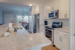 a kitchen with white cabinets and a counter top at Tranquil Harbour 102 in Mexico Beach