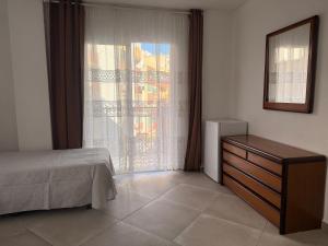 a bedroom with a bed and a dresser and a window at Habitación Doble con Aire cerca de la Playa in Benidorm +8 photos