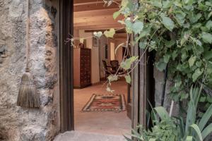 an entrance to a house with a broom at Mas Casalprim in Sant Feliu de Pallerols