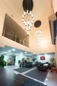 a lobby with two chandeliers and a living room at Rauza Hotel Tashkent in Tashkent +92 photos