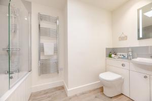 a white bathroom with a toilet and a shower at 3 Bed in Bamburgh oc-w31886 in Bamburgh +17 photos