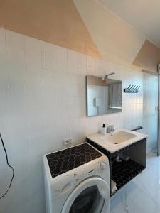 a washing machine in a bathroom with a sink at B&B MaKri in Boltiere +9 photos