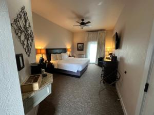 a hotel room with a bed and a window at Resort at Eagle Point Golf Club Lodging in Medford