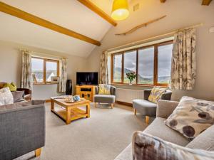 a living room with two couches and a tv at 3 Bed in Keswick oc-93590 in Threlkeld