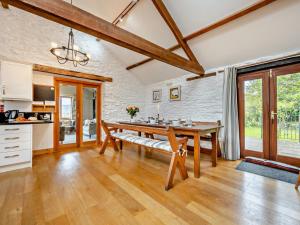 a kitchen and dining room with a wooden table at 3 Bed in Keswick oc-93590 in Threlkeld