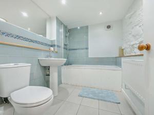 a bathroom with a toilet and a sink and a tub at 3 Bed in Keswick oc-93590 in Threlkeld +21 photos