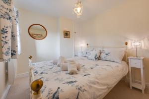 a bedroom with a blue and white bed with a mirror at 2 Bed in Holt oc-2195 in Holt