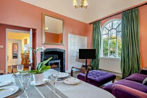 a living room with a table and a fireplace at 1 Bed in Wymondham oc-w30597 in Wymondham