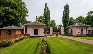 a house with a green lawn in front of a building at 1 Bed in Wymondham oc-w30597 in Wymondham