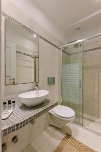 a bathroom with a sink and a toilet and a shower at Victoria Studios & Apartments in Mikri Vigla +98 photos