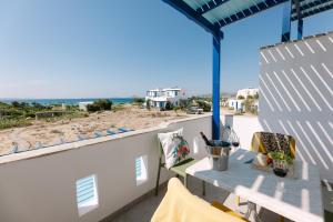 a balcony with a table and a view of the ocean at Victoria Studios & Apartments in Mikri Vigla