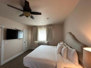 a bedroom with a bed with a ceiling fan at Resort at Eagle Point Golf Club Lodging in Medford