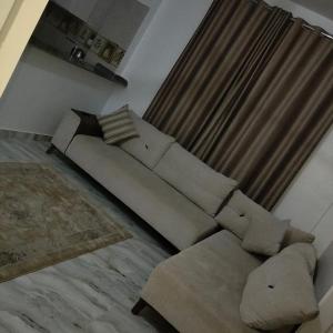 a living room with a couch and a rug at Diamond in Luxor
