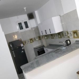 a kitchen with a sink and a refrigerator at Diamond in Luxor