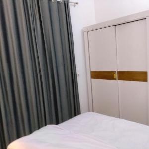 a bedroom with a bed and a curtain and a closet at Diamond in Luxor +41 photos