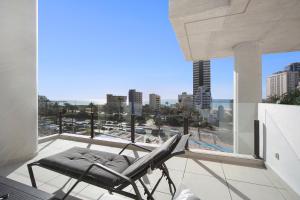 a chair on a balcony with a view of the city at Calpe Silver Tower 5B in Calpe