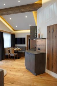 a kitchen with a counter and a dining room at Alpenapart Schmid in Niederthai