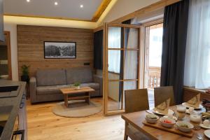 a living room with a couch and a table at Alpenapart Schmid in Niederthai