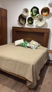 a bed in a room with plates on the wall at Mirador 28 in Platanitos