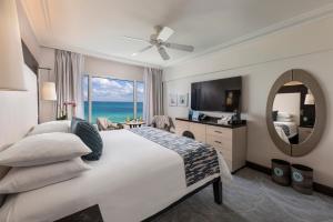 a bedroom with a large bed with a view of the ocean at The Palms Hotel & Spa in Miami Beach
