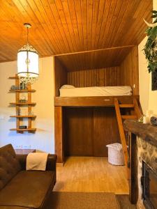 a living room with a bunk bed and a couch at O Caliu das Airas in León +18 photos