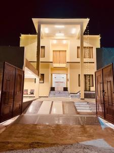 a large building with two doors and a courtyard at Shree Shivay Homestay in Sathri