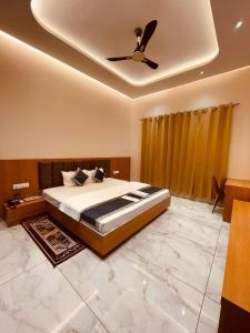 a bedroom with a bed and a ceiling fan at Shree Shivay Homestay in Sathri +26 photos