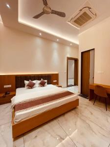 a bedroom with a large bed with a ceiling at Shree Shivay Homestay in Sathri