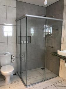 a bathroom with a shower with a toilet and a sink at Pousada Joaninha in Tiradentes +57 photos