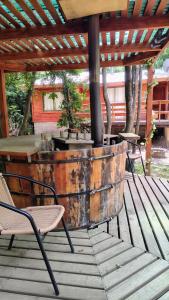 an old wine barrel sitting on a wooden deck at Cabañas Tía Marce, Los Lleuques in Recinto