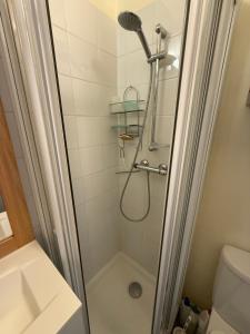 a shower with a shower head in a bathroom at Location studio à Serre Chevalier 1350 in Saint-Chaffrey