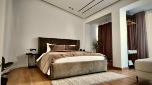 a bedroom with a large bed and a large window at Fivenco Suites - Private Suites w King Bed Modern in Tirana