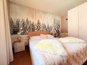 a bedroom with a bed with a mural of trees at Maison Poluc - Suite Alpine in Champoluc +46 photos