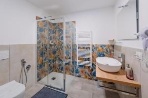 a bathroom with a shower and a sink and a toilet at Franciacorta Rooms in Corte Franca +134 photos