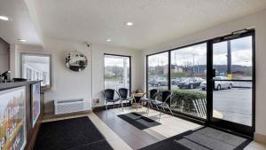 a living room with chairs and a table and a large window at Motel 6 Chattanooga, TN in Silverdale