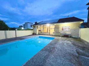 a swimming pool in front of a house at Casa da lagoa in Imbituba
