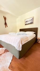 a bedroom with a large bed with white sheets at Maison Poluc - Chiaro di Luna in Champoluc +46 photos