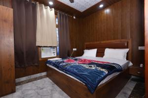 a bedroom with a bed with a wooden wall at New Awadhesh Singh Hotel in Chauri +42 photos