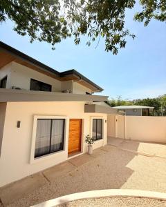 a large white house with a driveway at Brianne's Place in Playa hermosa